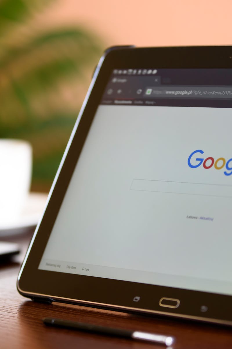 Samsung tablet on desk showing Google homepage, perfect for technology-related content.